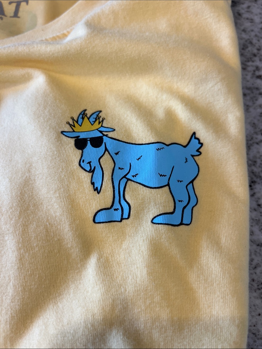 GOAT Men's Short Sleeve Tee in Pale Yellow with Blue Goat Graphic